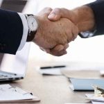 Business people shaking hands together