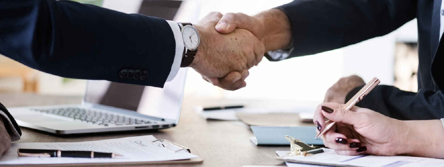 Business people shaking hands together